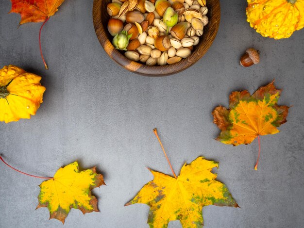 Wooden bowl with mixed nuts Healthy food and snack pistachios almonds hazelnuts and pumpkin seeds autumn harvest