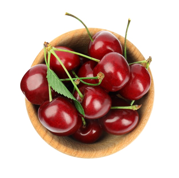 Wooden bowl with ripe sweet cherries on white background top view