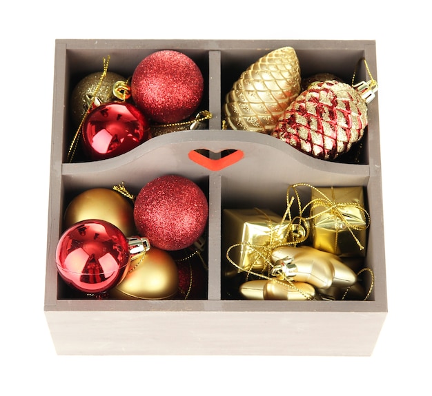 Wooden box filled with christmas decorations, isolated on white