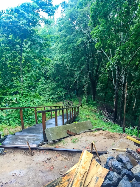 Wooden bridge in the forest rain in the autumn morning ukraine