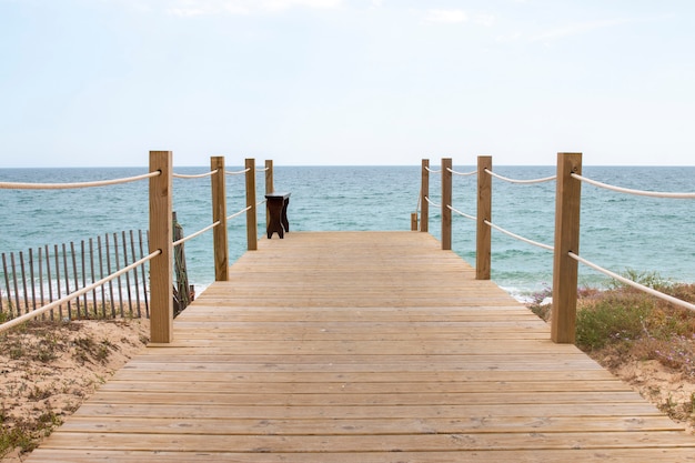 Photo wooden bridge through sand dunes