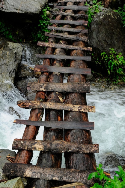 Wooden bridge over wild river