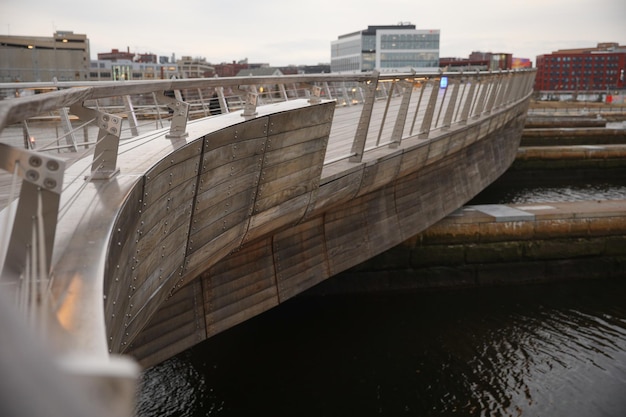 A wooden bridge with a sign that says " the word " on it "