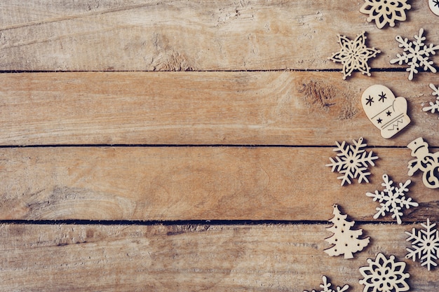 Wooden brown christmas background with snowflakes and christmas decoration.