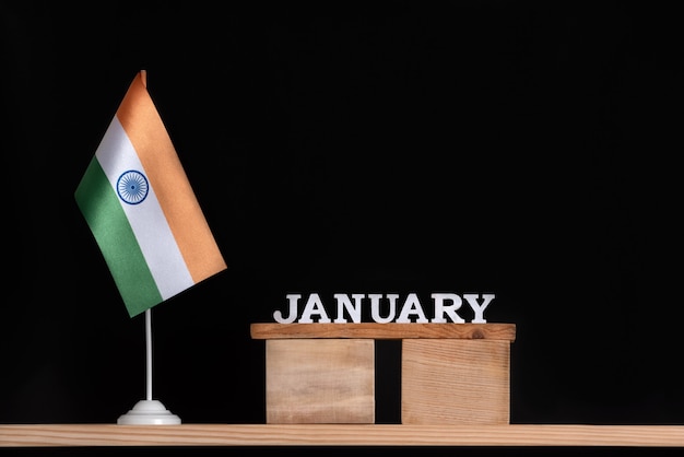 Wooden calendar of January with Indian flag on black space. Holidays of India in January.