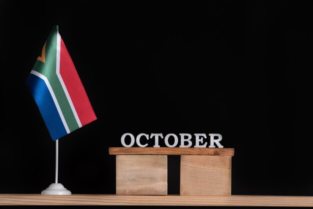 Wooden calendar of October with RSA flag on black background Dates of South Africa in October