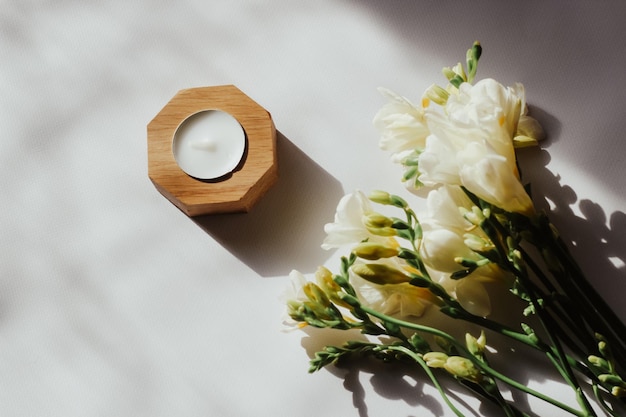 Wooden candlestick on the background of wooden figured boards