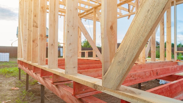 Wooden carcass on metal supports at house construction site premium photo