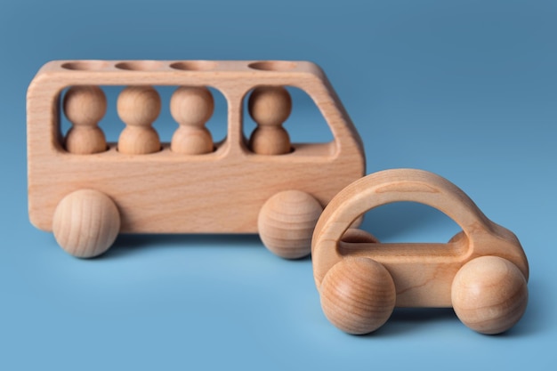 Wooden cars baby toy for child on blue background eco friendly plastic free toddler kids toys educat...