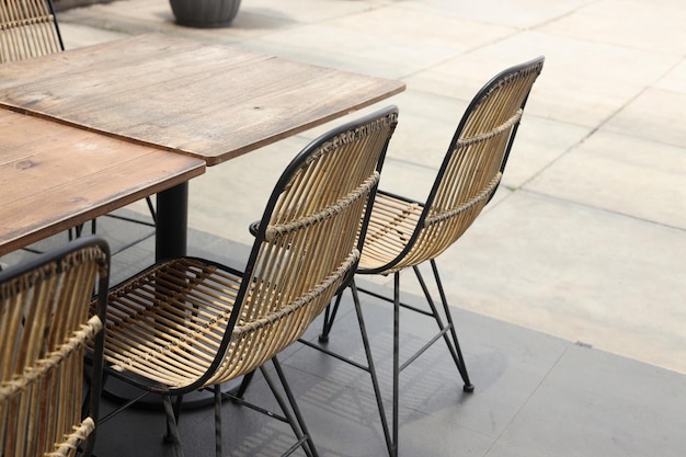 Wooden chairs and table in cafeteria terrace.