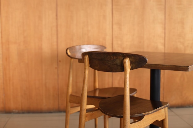 Wooden chairs and table in cafeteria.