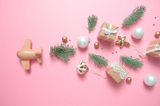 Wooden children's plane on a pink background