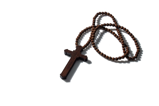 Wooden christian cross necklace isolation on white background