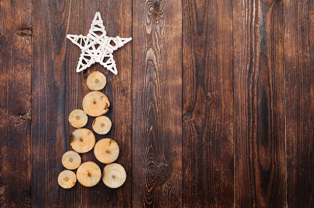 Wooden Christmas tree and star on wooden surface 