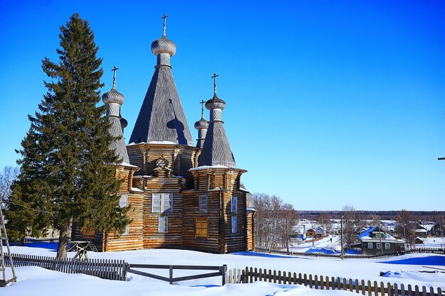 wooden church in the Russian north landscape in winter, architecture historical religion Christianity