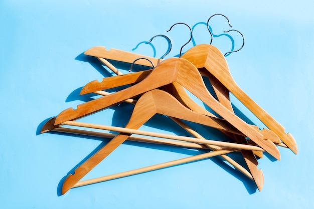 Wooden clothes hangers on blue background