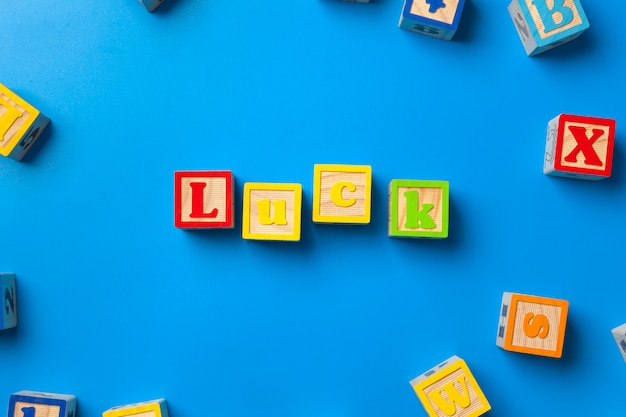 Wooden colorful alphabet blocks on blue background