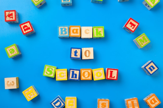 Wooden colorful alphabet blocks on blue