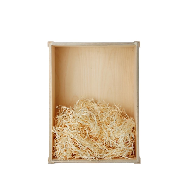 Wooden crate with shavings on white background top view