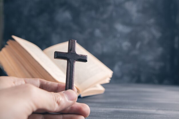 Wooden cross on the book