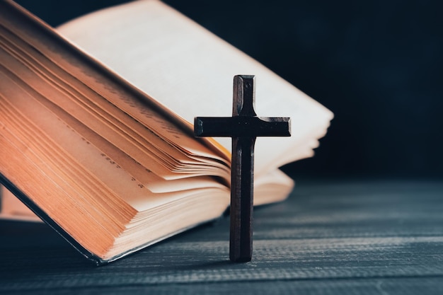 Wooden cross on the book