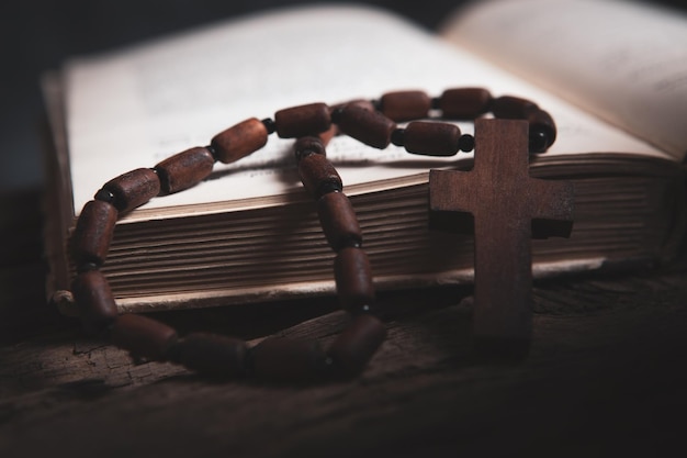 Wooden cross on the book