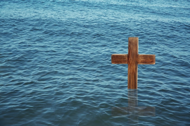 Wooden cross in river for religious ritual known as baptism