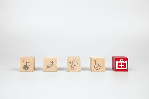 Wooden cube toy blocks with medical and first aid kid icon