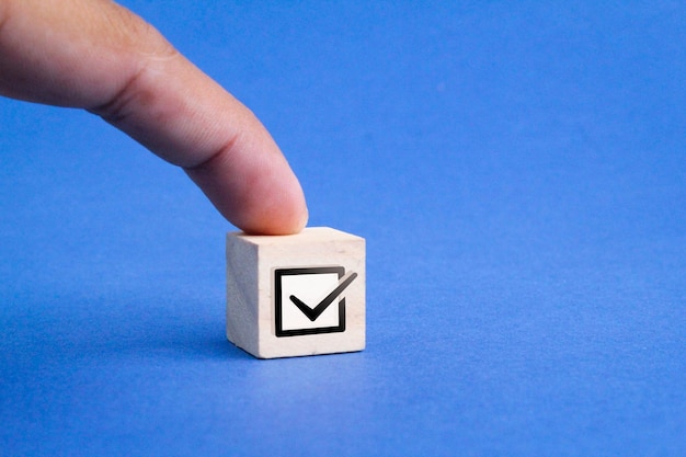 wooden cube with right sign icon. correct sign concept. the concept of a checklist or check mark