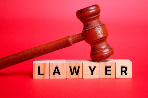 wooden cube with the word lawyer. the concept of a lawyer or court