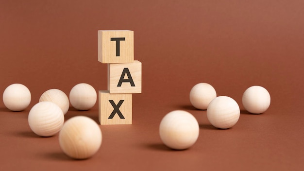 Wooden cubes block with alphabet combine abbreviation TAX