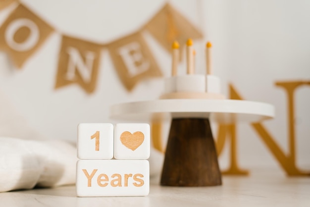 Wooden cubes a perpetual calendar with one year Photo zone of the celebration of the first year of the baby with a copy space