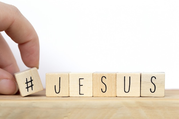 Wooden cubes with a hashtag and the word Jesus, social media concept