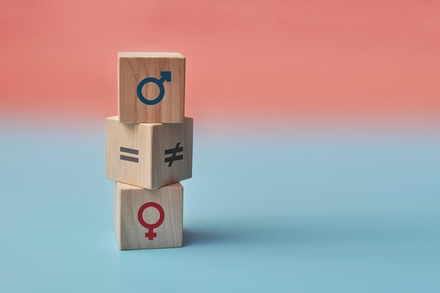 Wooden cubes with icons of men and women and equality and not equality between them