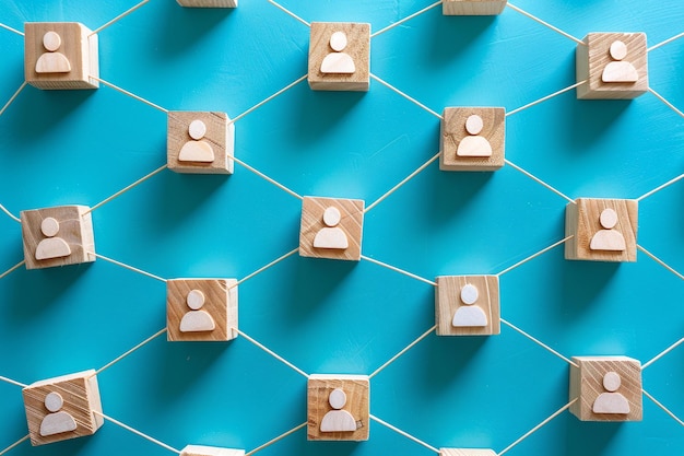 Wooden cubes with the image of person are connected with thread