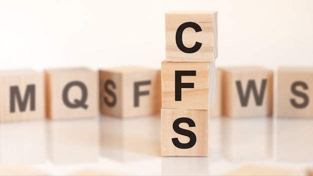 Wooden cubes with letters CFS arranged in a vertical pyramidbusiness concept. CFS short for Consolidated Financial Statement