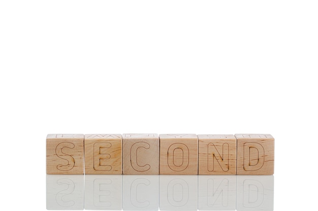 Wooden cubes with letters second on a white background