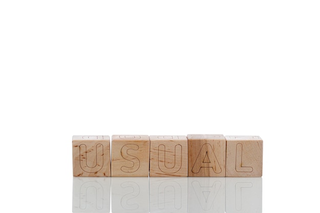 Wooden cubes with letters usual on a white background