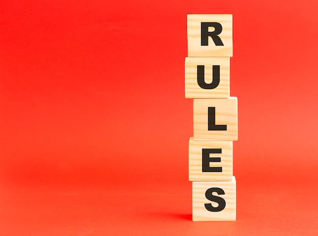 Wooden cubes with letters. Wooden cubes on a red background.