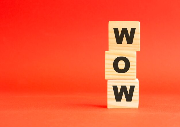 Wooden cubes with letters. For your design and concept. Wooden cubes on a red background. Free space on the left.