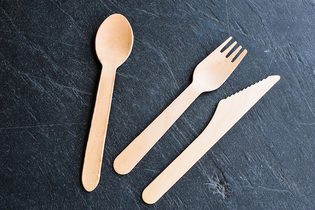 wooden cutlery on a natural slate background