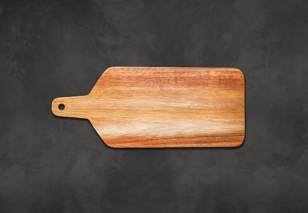 Wooden cutting board on concrete background