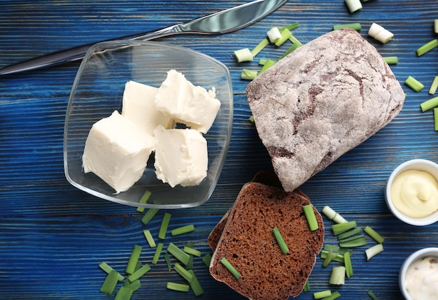 Wooden cutting board with sliced loaf of beer bread and butter