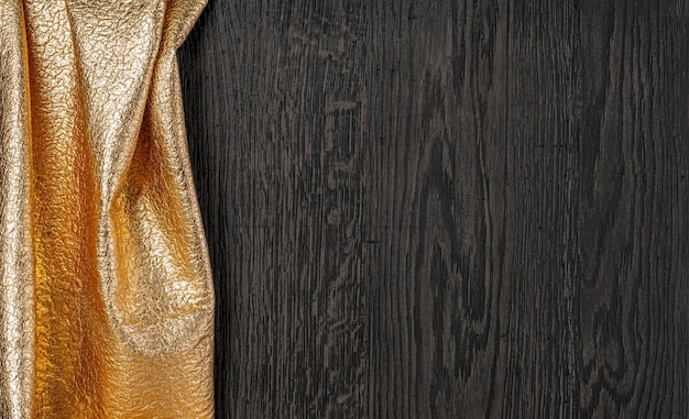 Wooden dark texture with gold textil