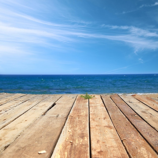 Wooden deck with sea and blue sky