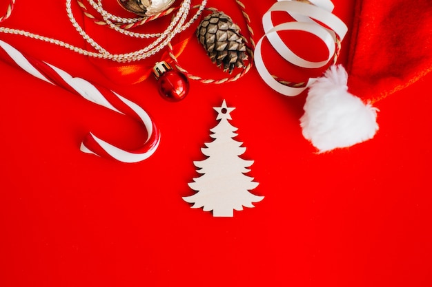 Wooden decoration in the form of a Christmas tree on red 