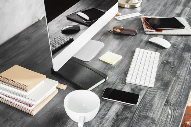 Wooden desk with gadgets and supplies top