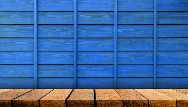 Wooden display board shelf table counter with copy space for advertising backdrop and background with blue wooden wall background.