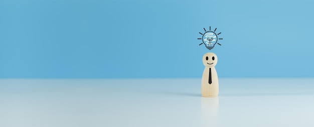 Wooden doll people human women standing with light bulb icon idea intelligent think power blue background creative and idea concept copy space