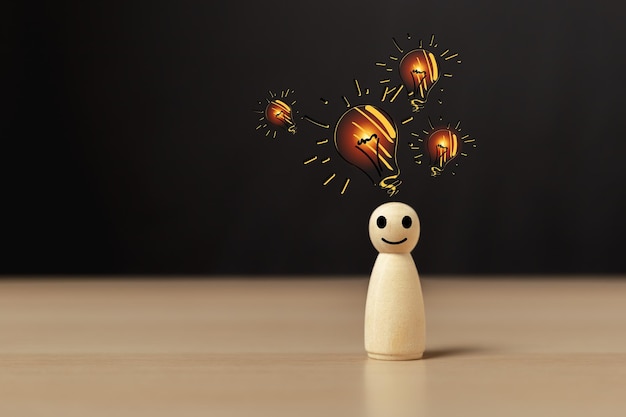 Wooden doll people human women standing with light bulb icon idea intelligent think power creative and idea concept